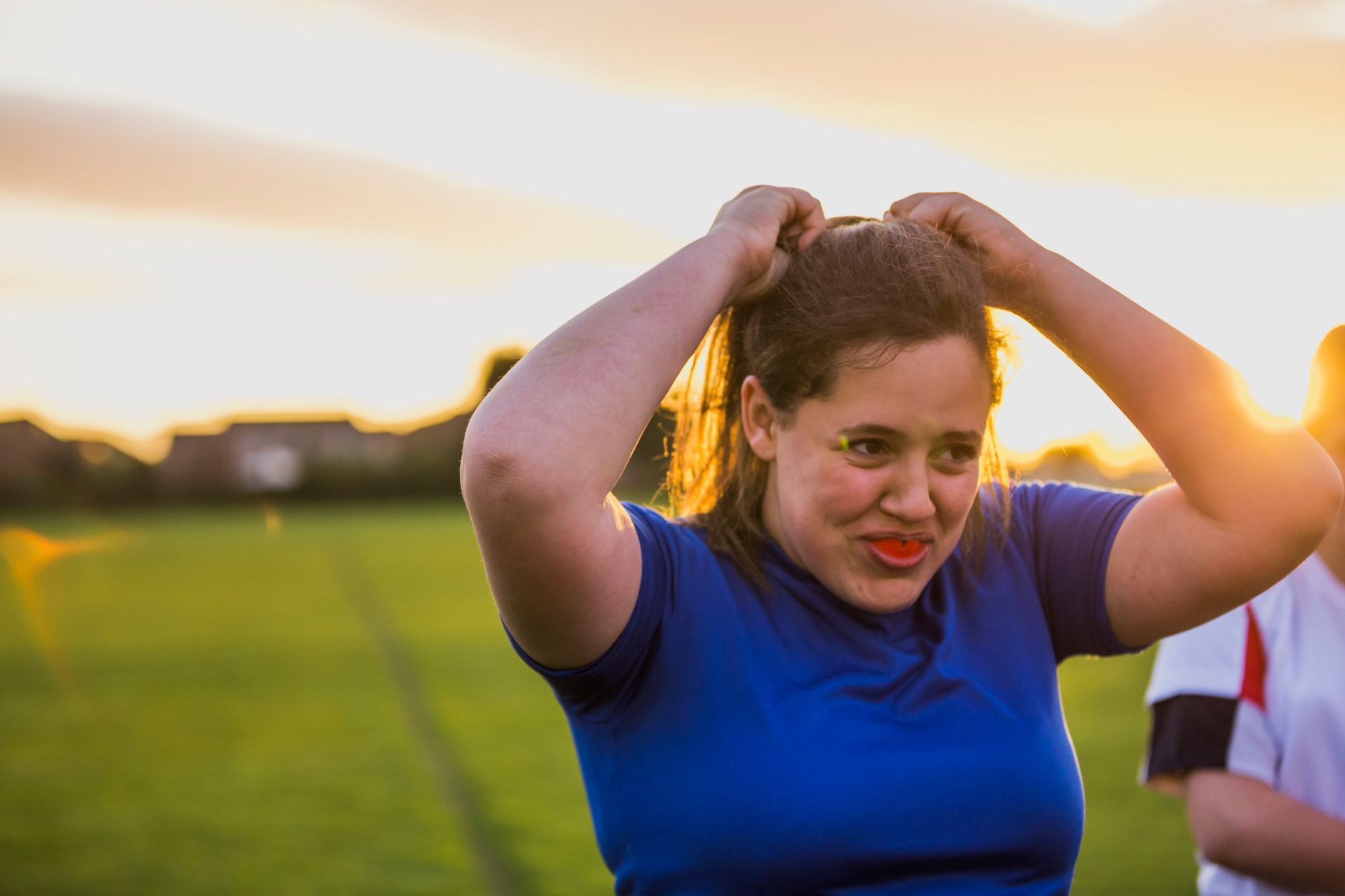 A little girl is sitting in a dental chair while a dentist examines her teeth.