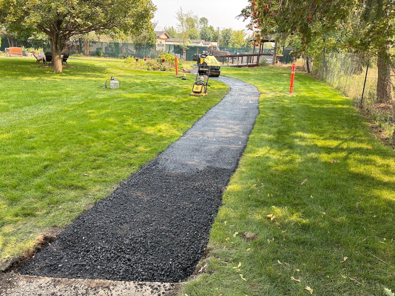Orange and white traffic cones surrounding a road work site on a street.