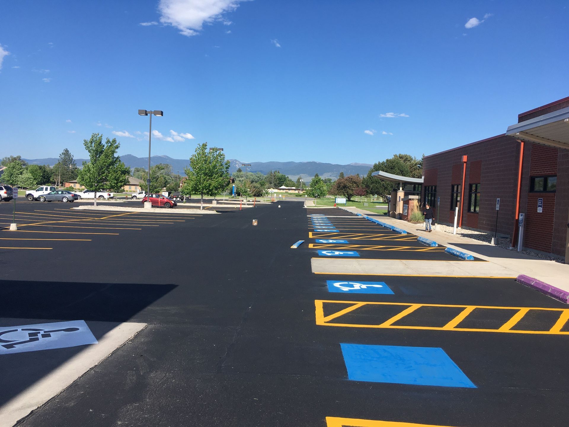 Line painting machine on asphalt, painting white lines.