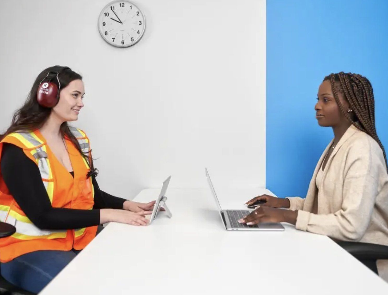 Woman giving hearing test to employee