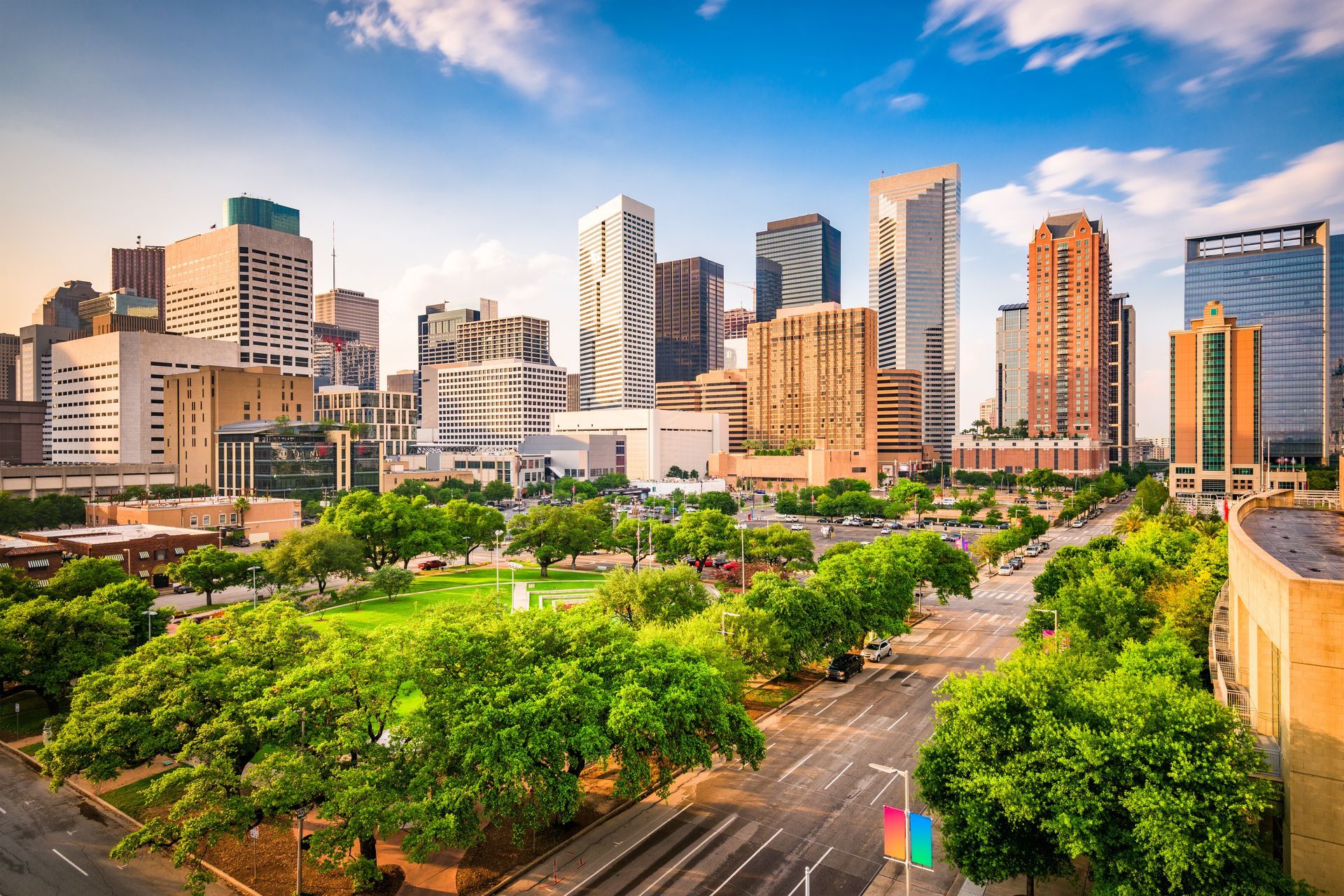 Downtown Houston skyline with skyscrapers and green spaces.