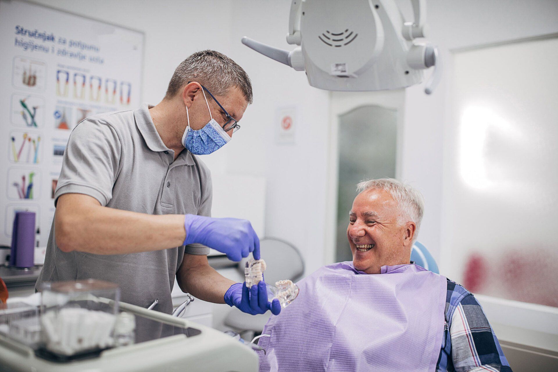 Dentist showing denture work — Rochester, MN — Broadway Dental Care