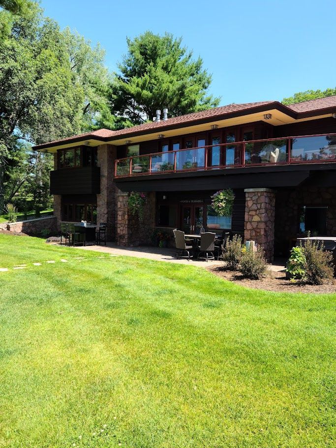 A large house with a large lawn in front of it