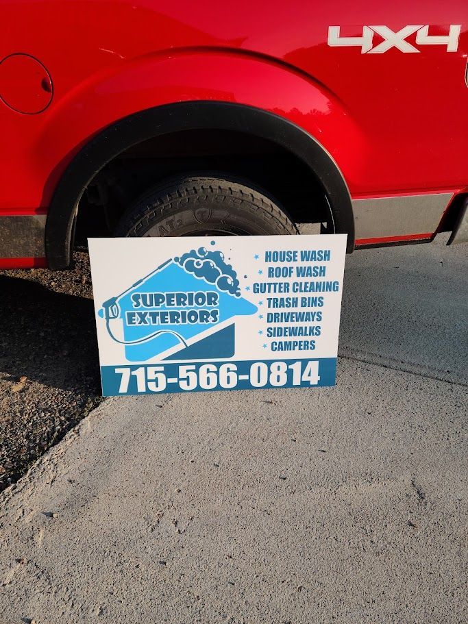 A red truck with a sign on the side that says superior exteriors