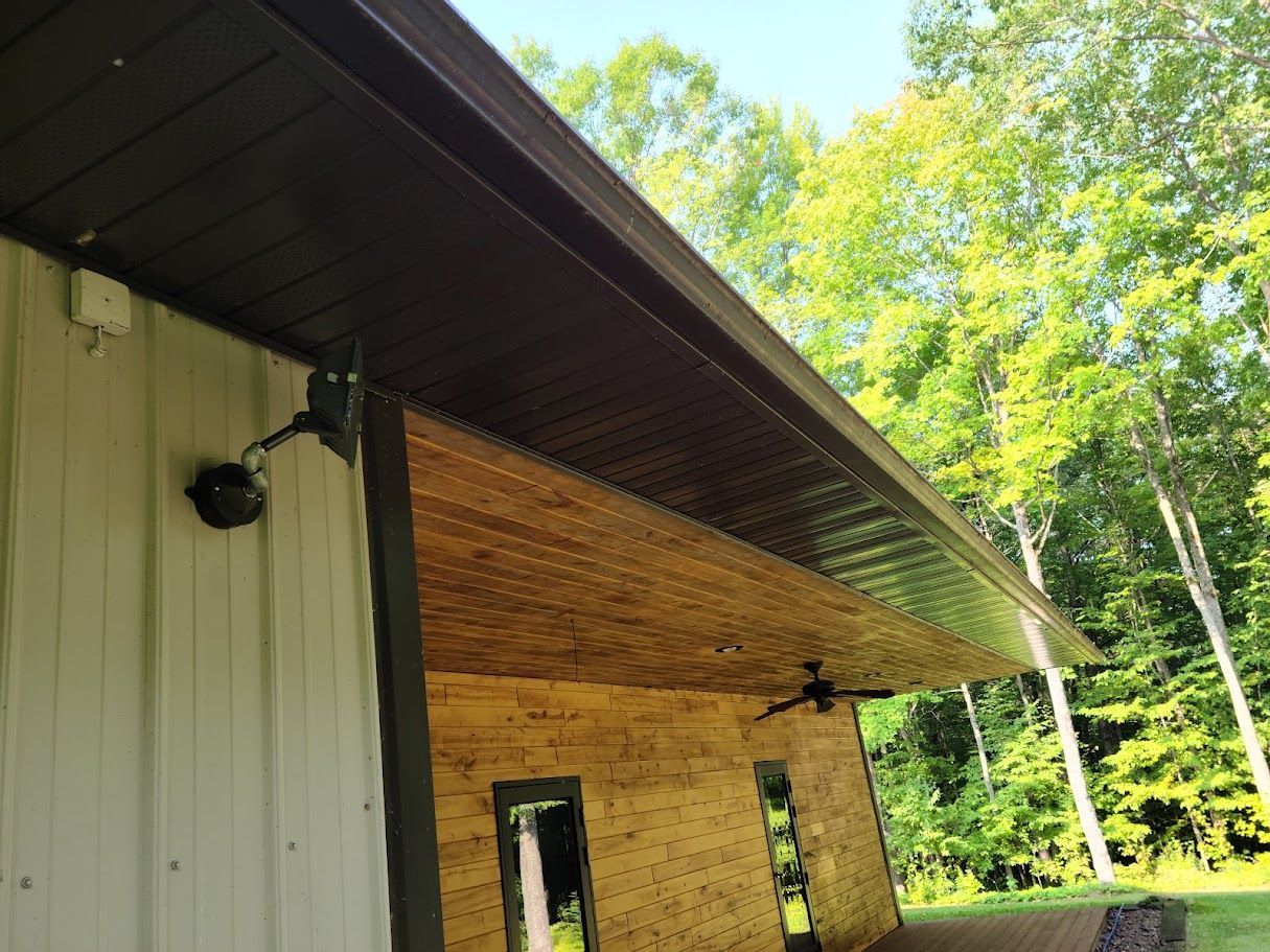 A white building with a wooden roof and a ceiling fan.