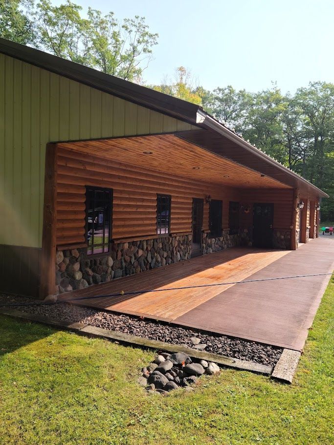 A large building with a wooden roof and a stone wall.