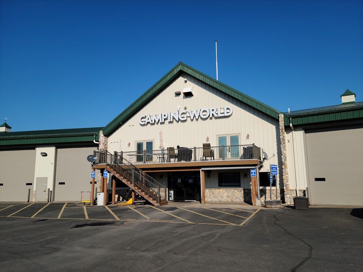A large white building with a green roof and stairs leading up to it