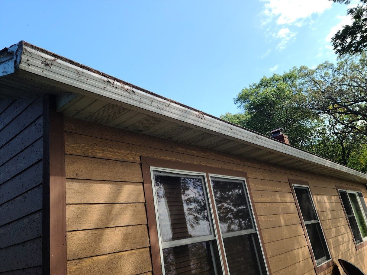 A house with a lot of windows and a blue sky in the background