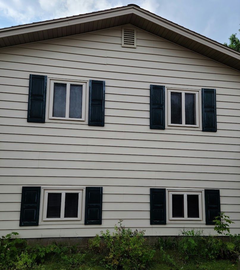 A white house with black shutters on the windows