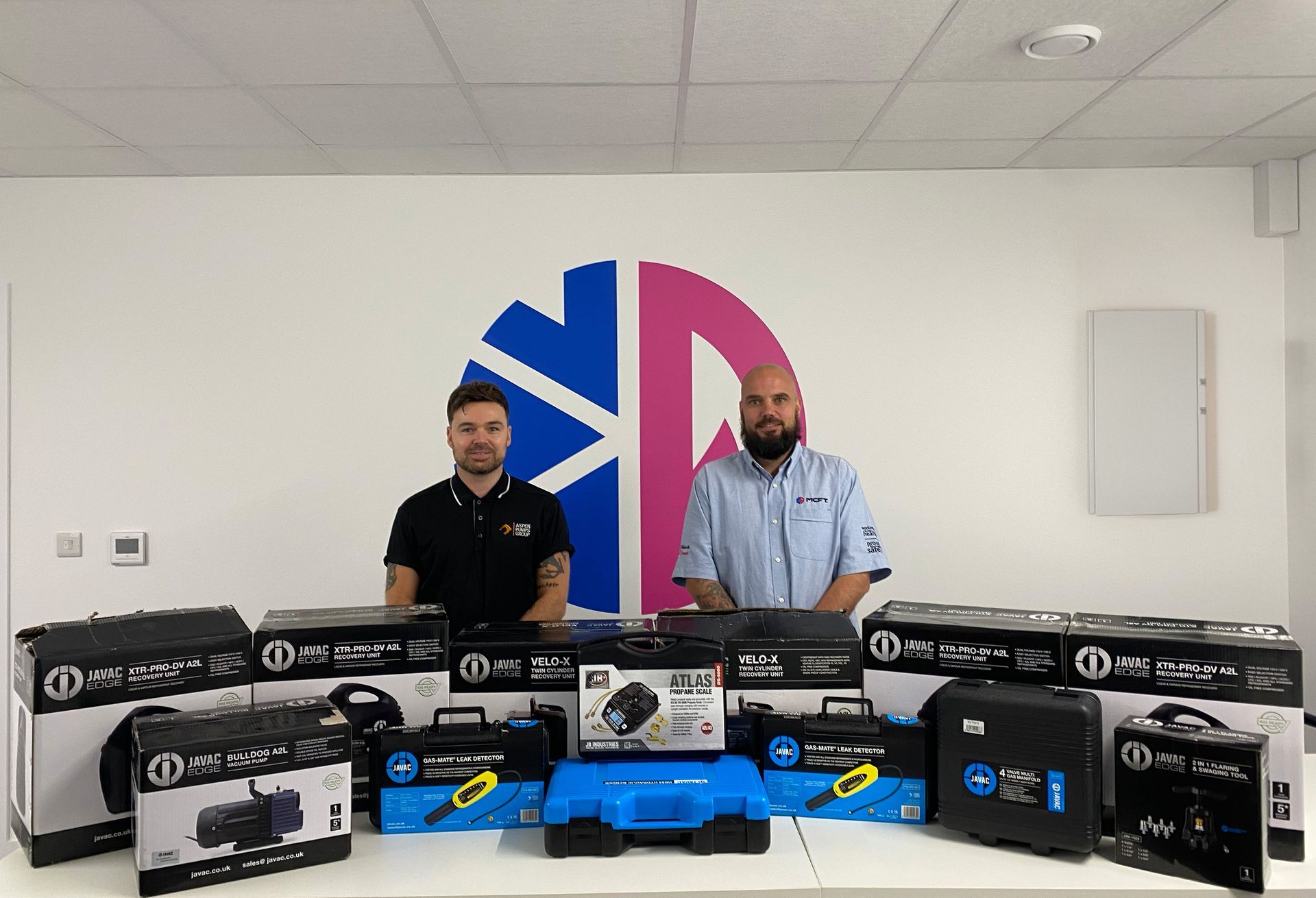 Jason, Aspen Pumps, and Collin, Refrigeration Training Manager, with the donated equipment