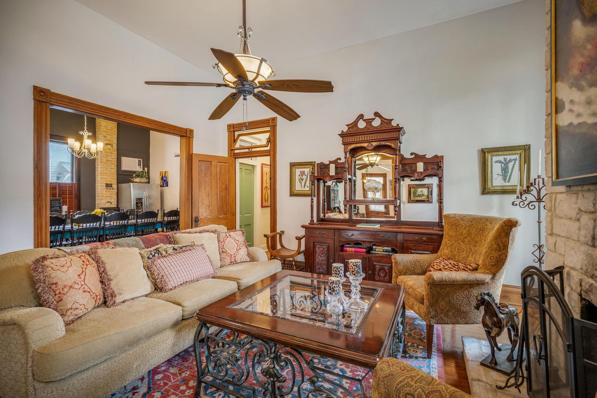 A living room filled with furniture and a ceiling fan.