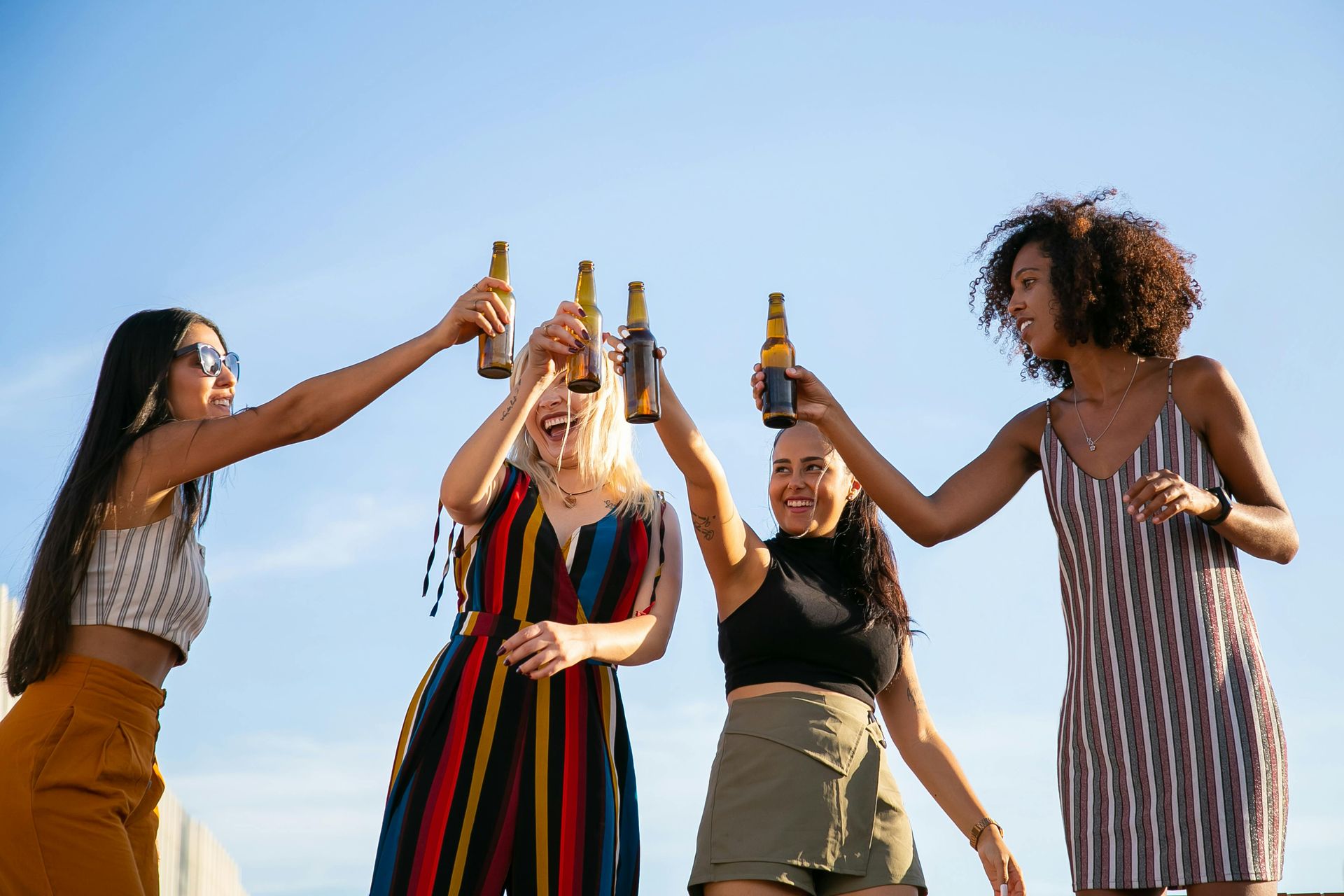 A group of people are sitting on a couch eating food.