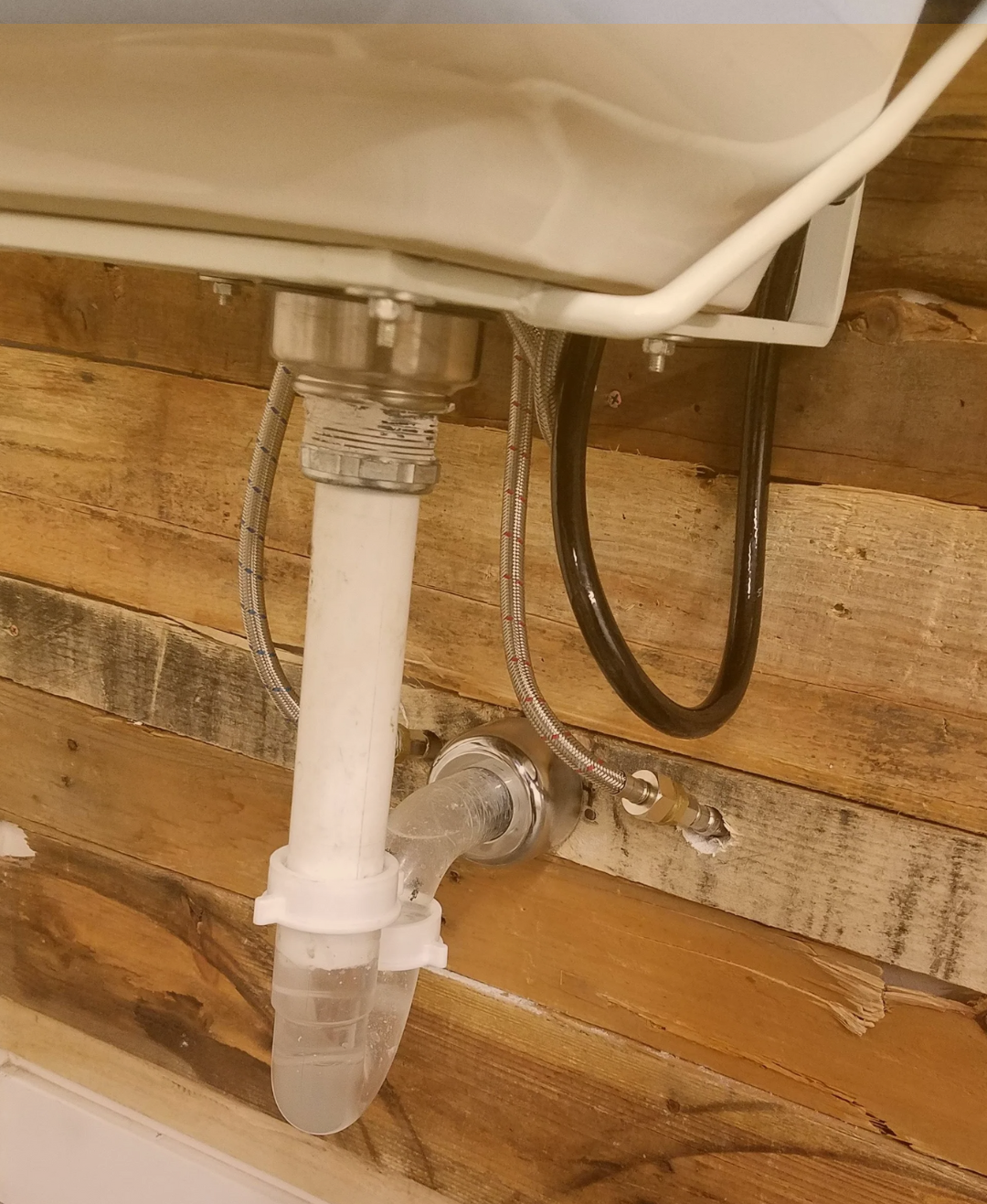 Residential drain cleaning and pipe inspection under bathroom sink
