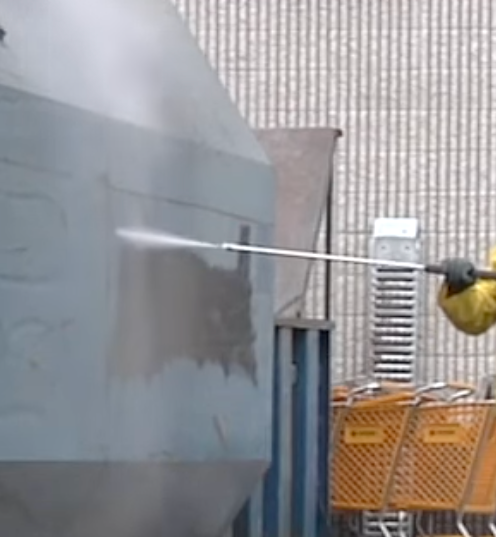 A man is cleaning a roof high pressure washer.