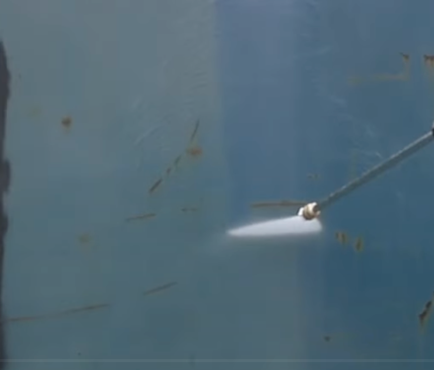 A picture of a person doing soft wash cleaning.