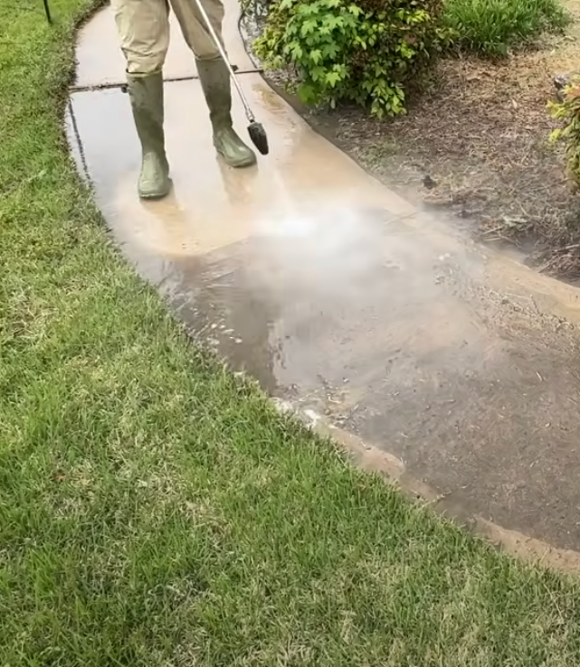 Dumpster pad cleaning using a high pressure washer.