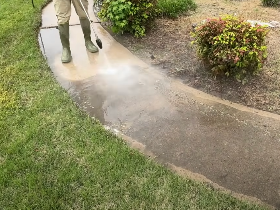 Dumpster pad cleaning using a high pressure washer.