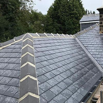 A slate roof is being installed on a house.