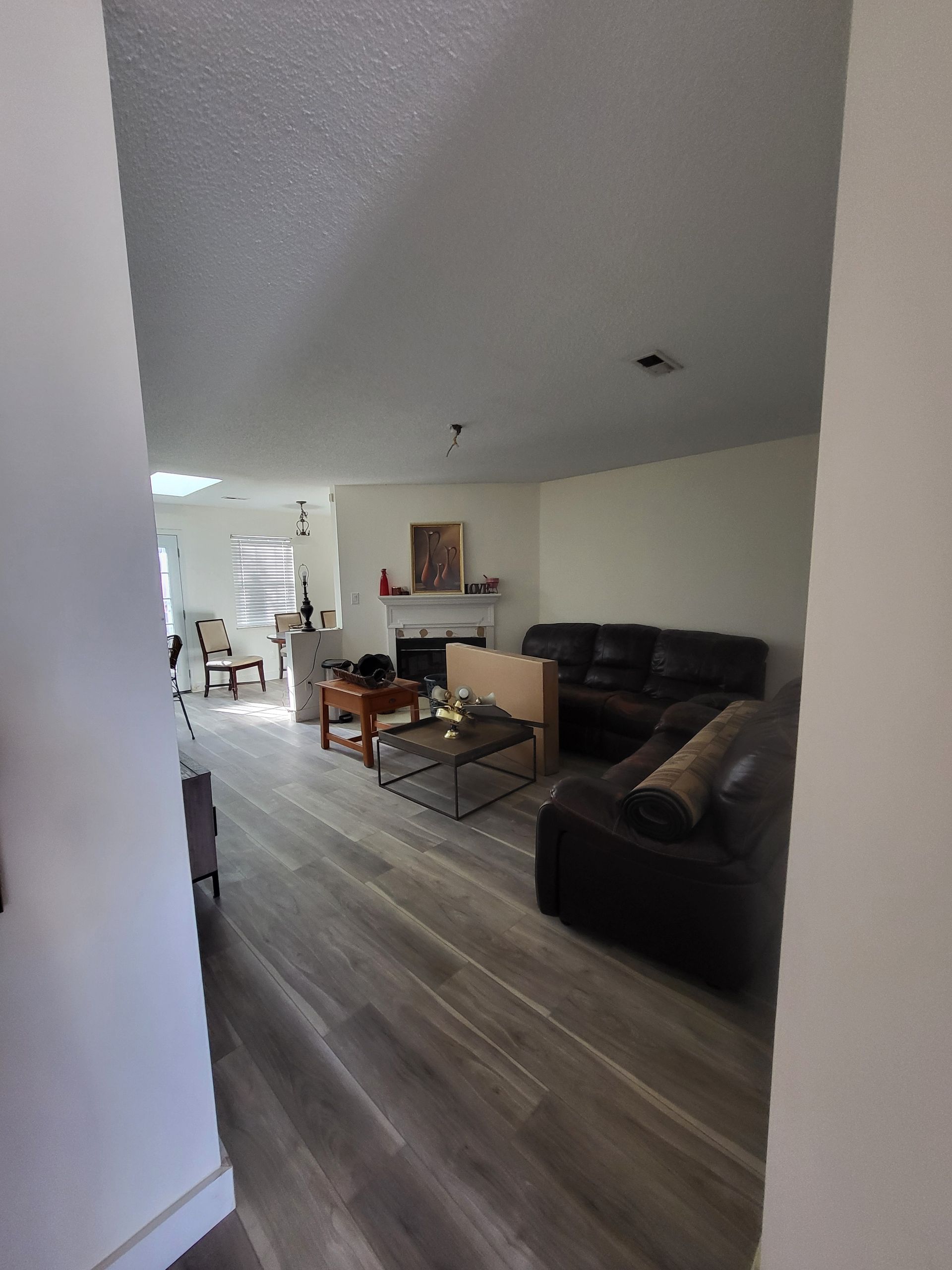 A living room with a couch , table and fireplace