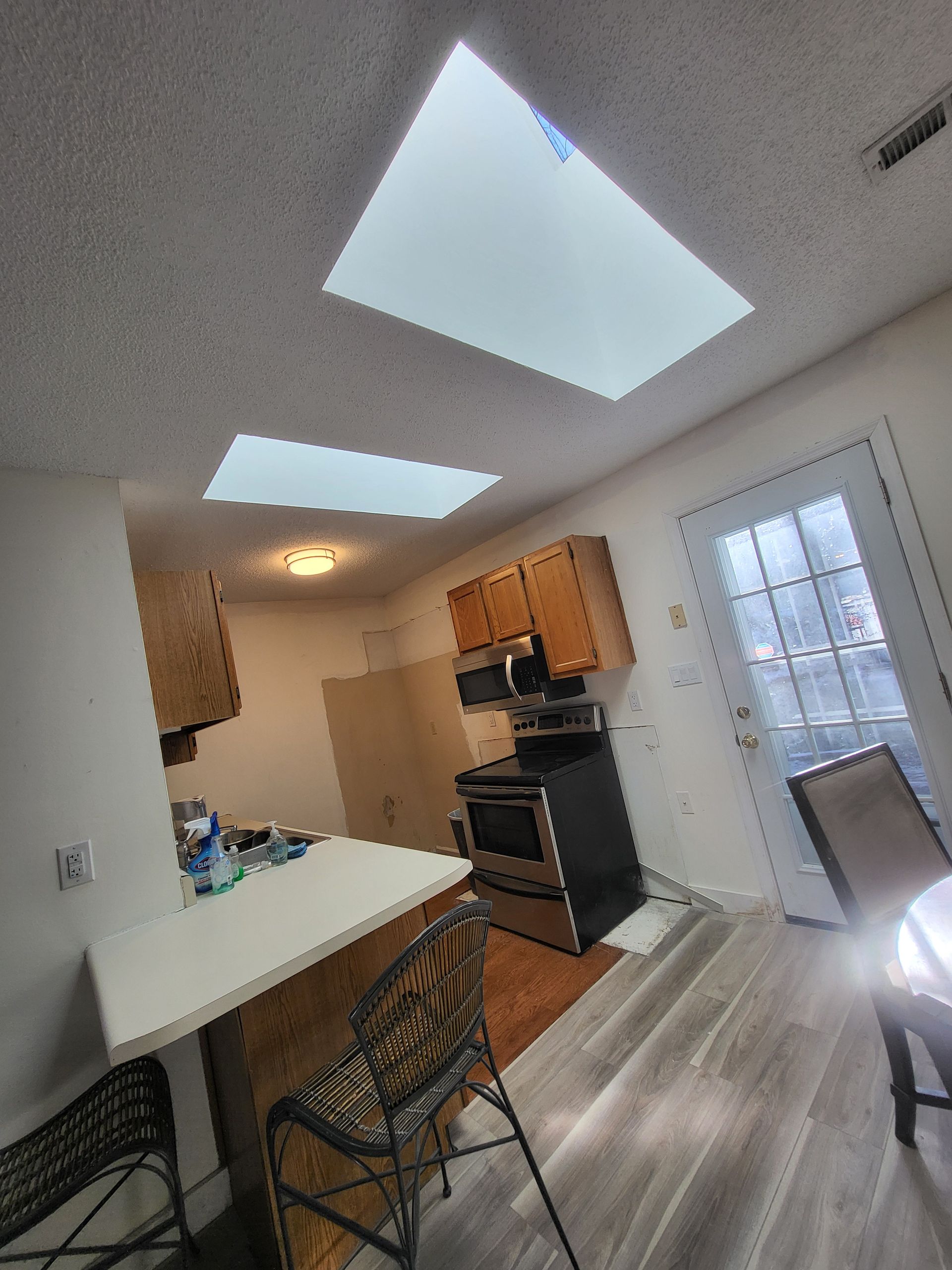 There is a skylight in the ceiling of the kitchen.