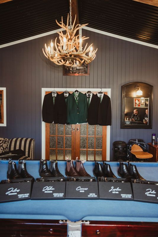 A pool table with a row of shoes and jackets on it upstairs at Aberfeldy Barn.