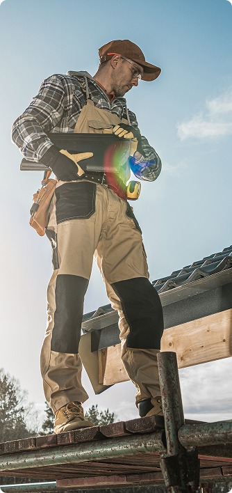 A group of people are posing for a picture in front of their trucks.