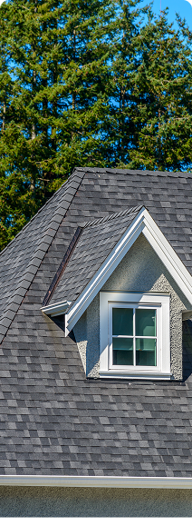A yellow van is parked on the side of the road in front of a house.