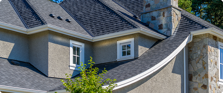A large white house with a large porch and red shutters.