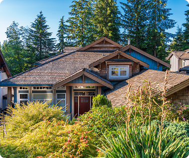 A white house with a gray roof and a brown trim