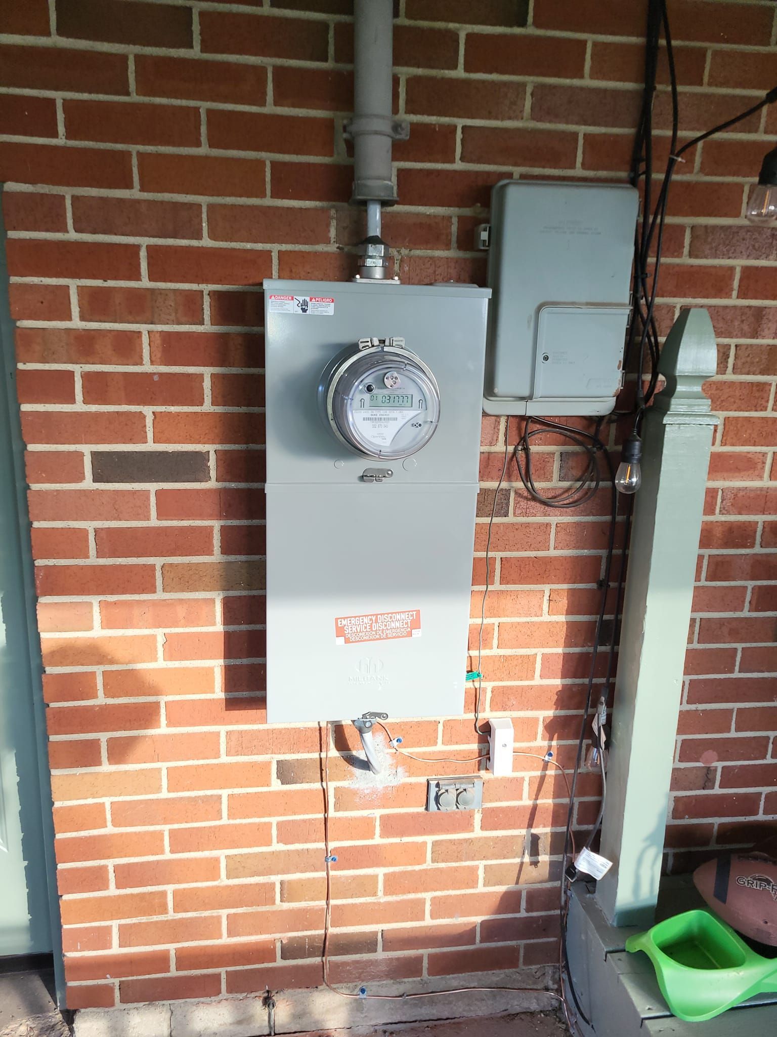 A brick wall with a meter mounted on it