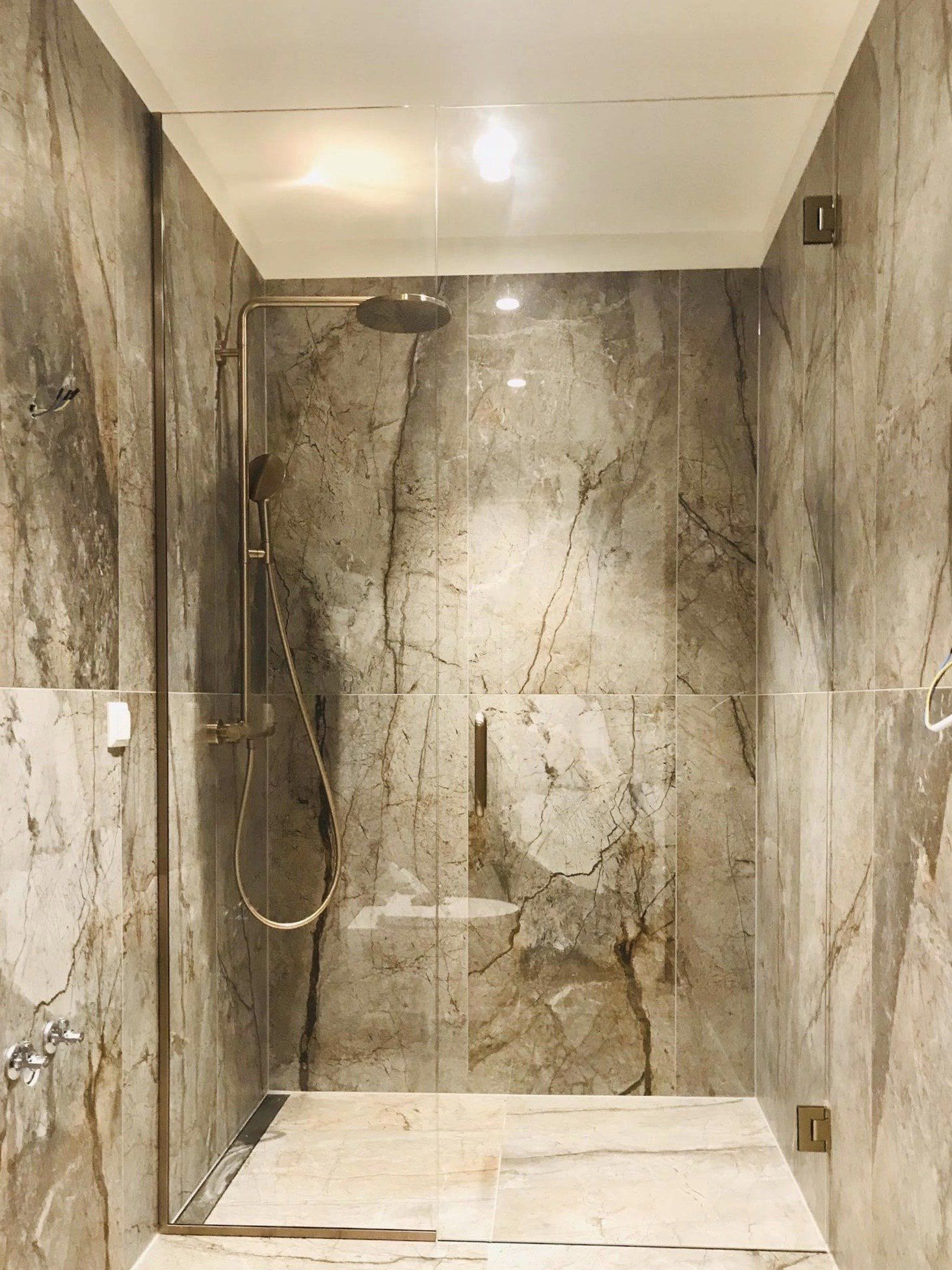 Harjatud pronksi furnituuriga dušiuks ja dušiklaas