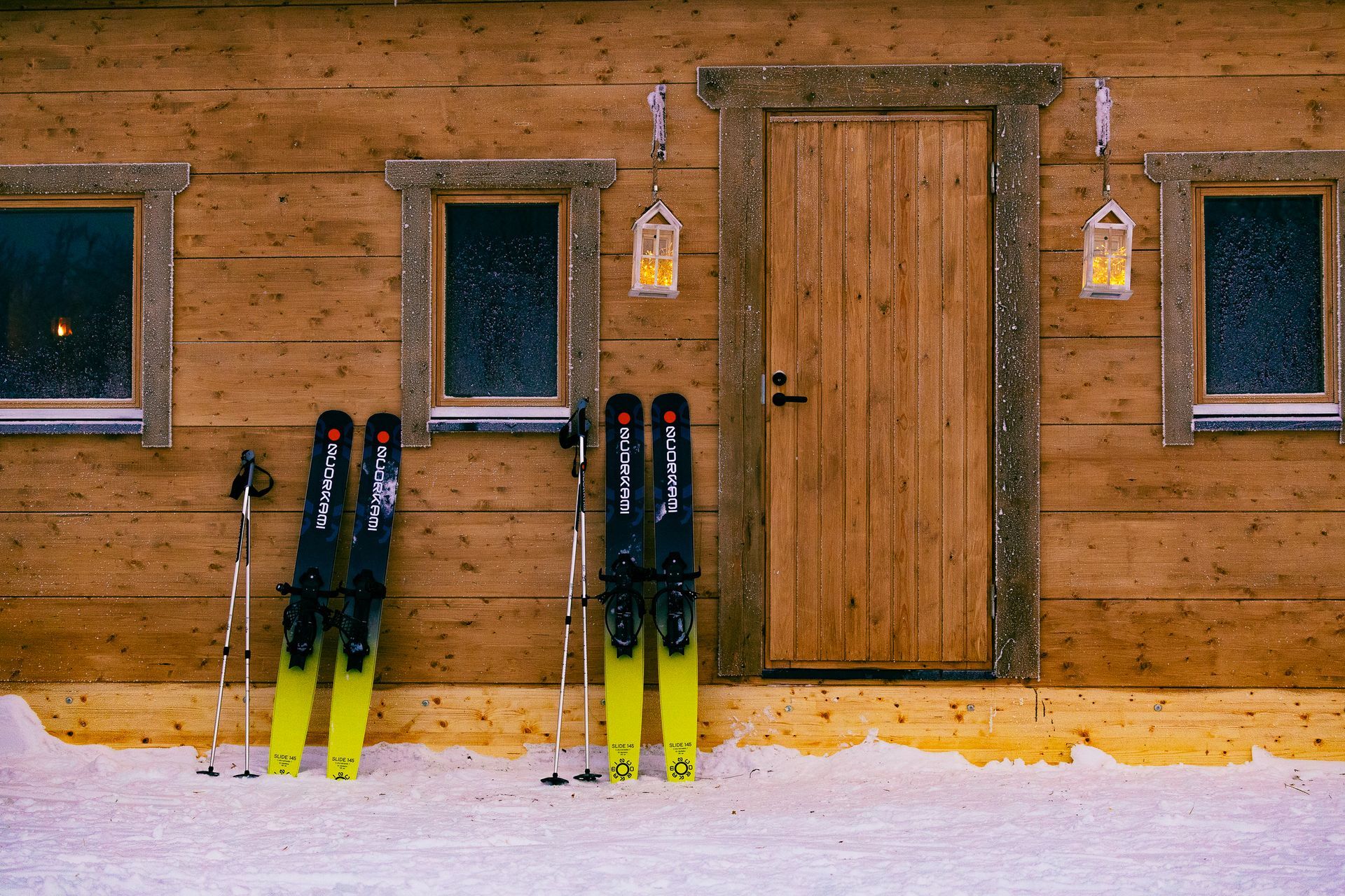 Snowshoes in front of Log cabin.