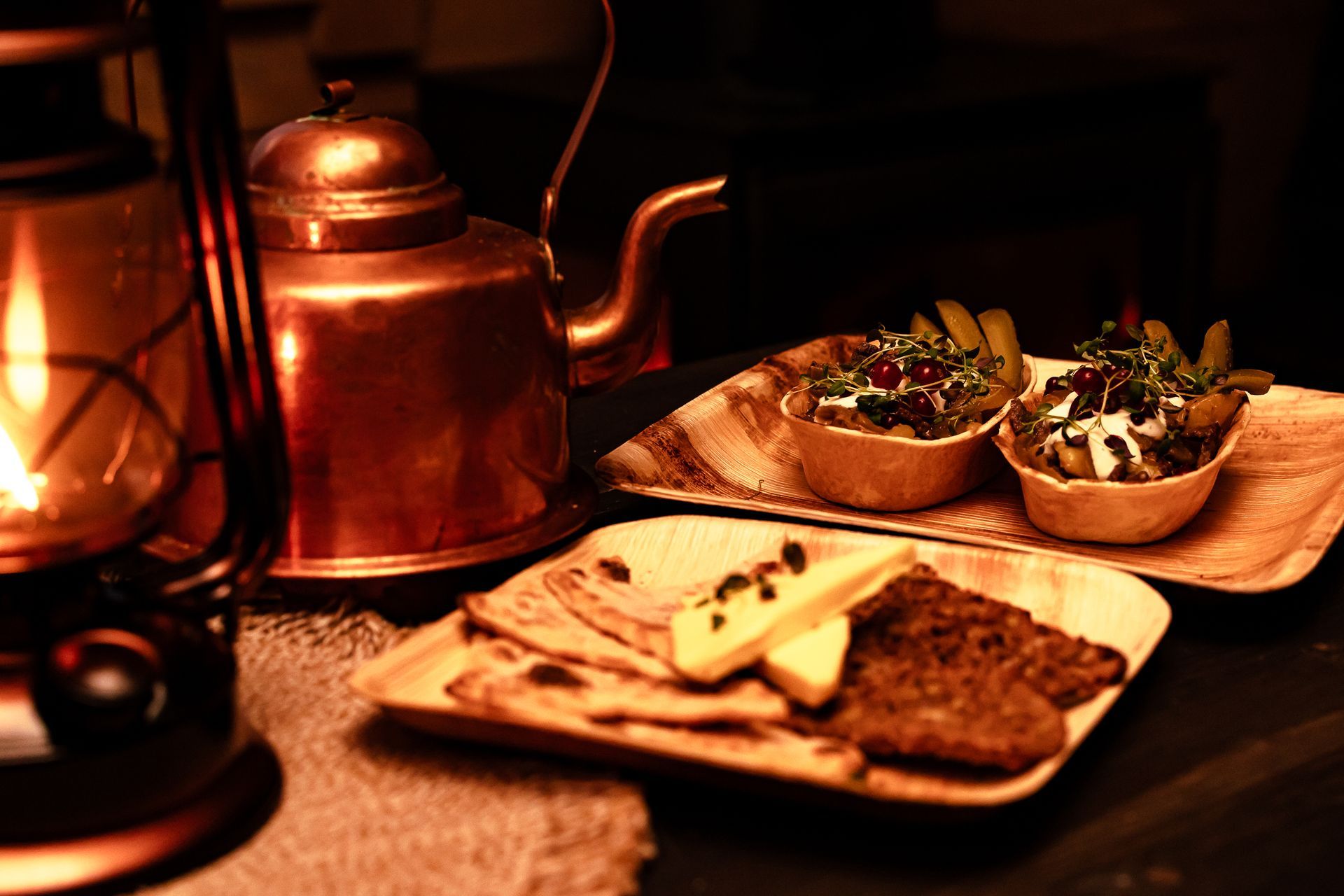 Copper pot and local food on a wooden plate.