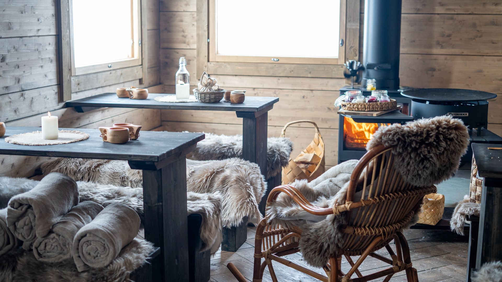 Rustic interior of log cabin with rocking chair in front of the fire place.