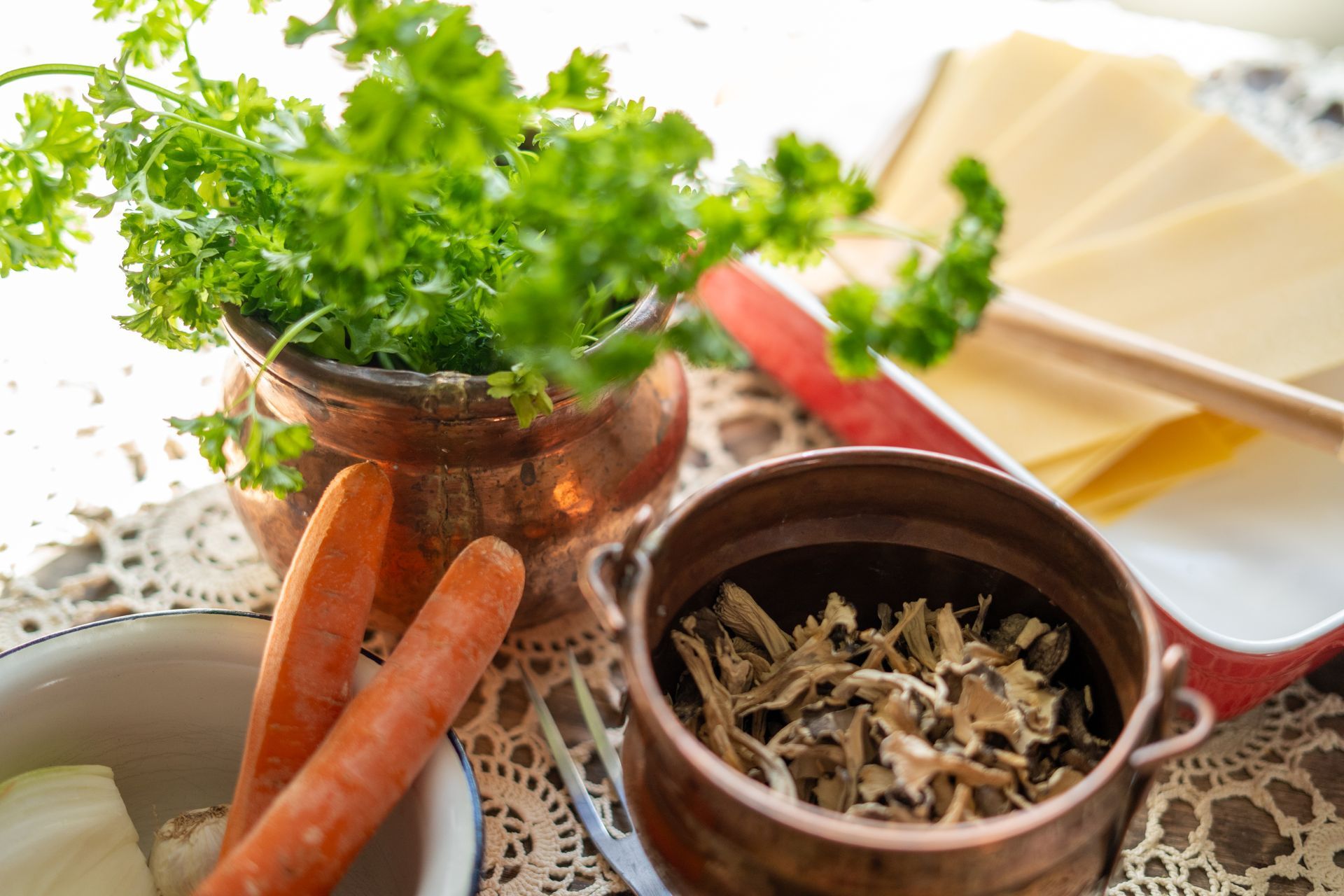 Carrots, herbs and mushroom in a kitchen setting