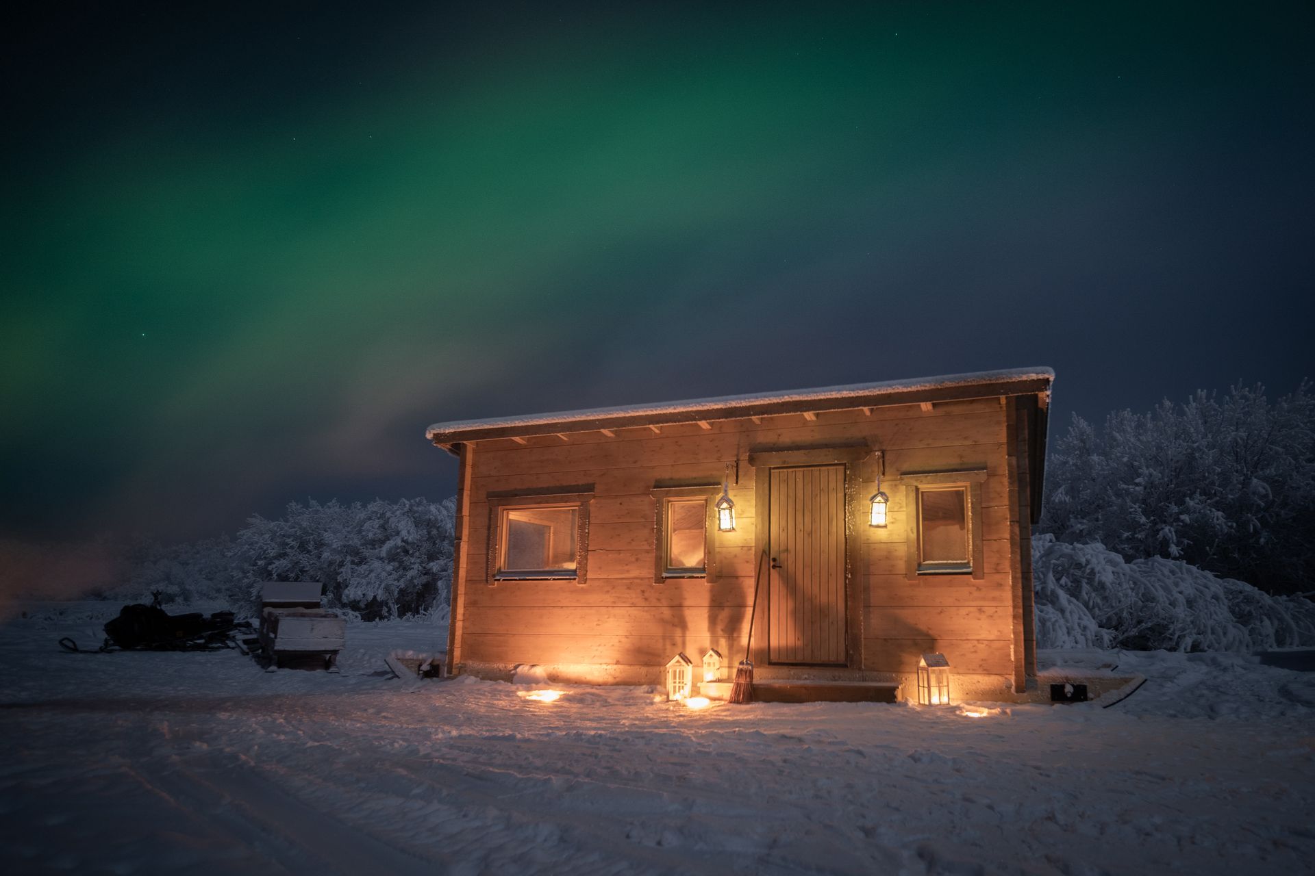 Log cabin under Northern Lights.