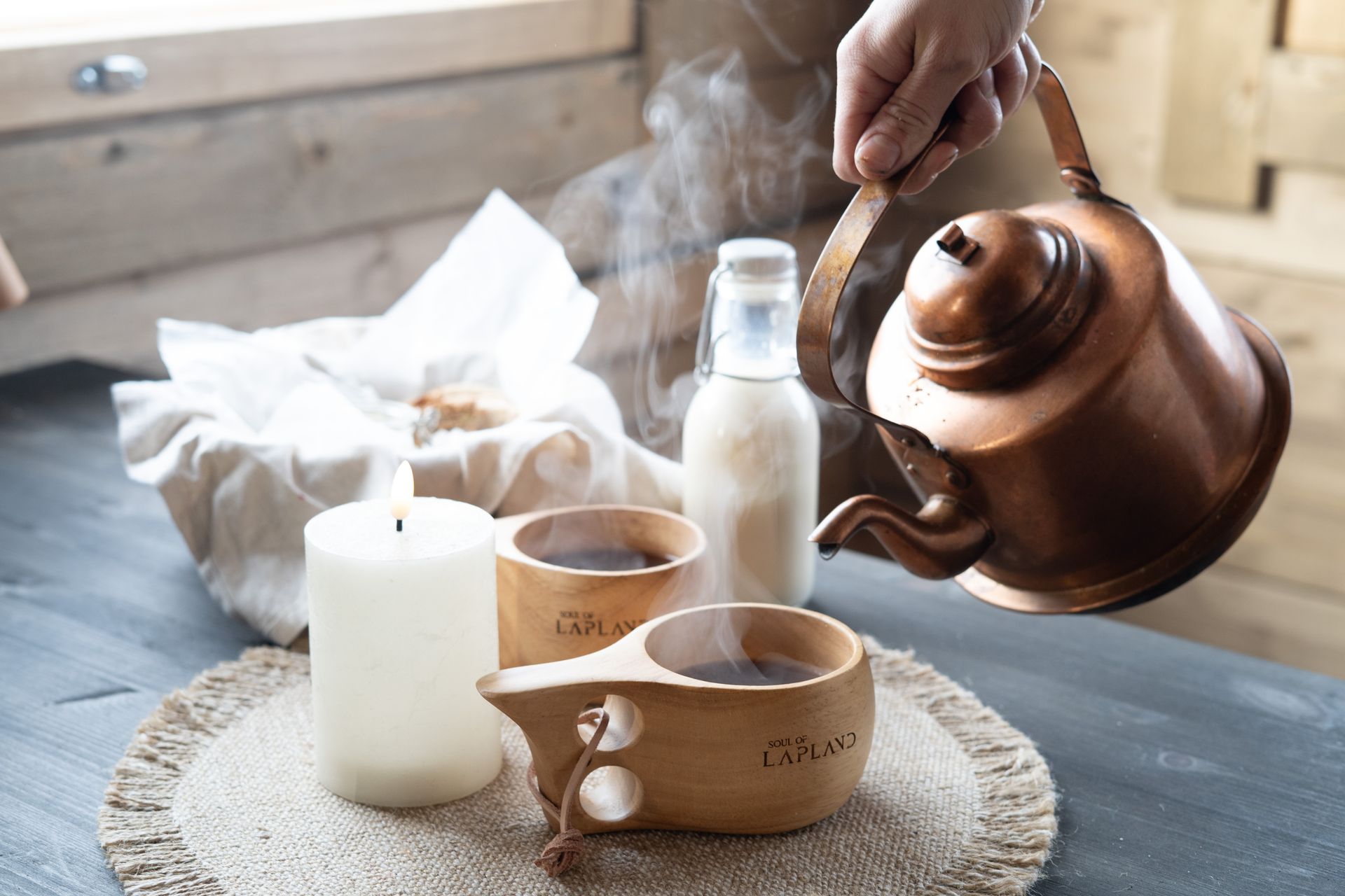 Pouring coffee from copper pot.