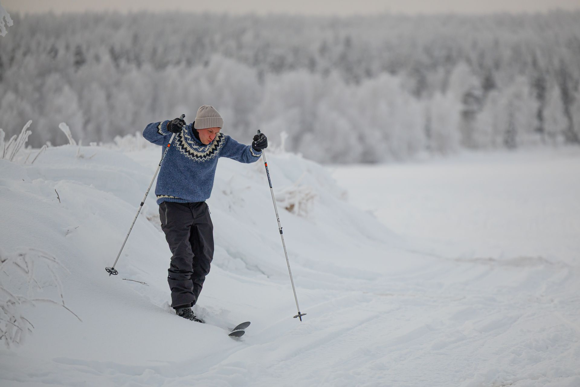 Man snowshoeing in winter landscape.