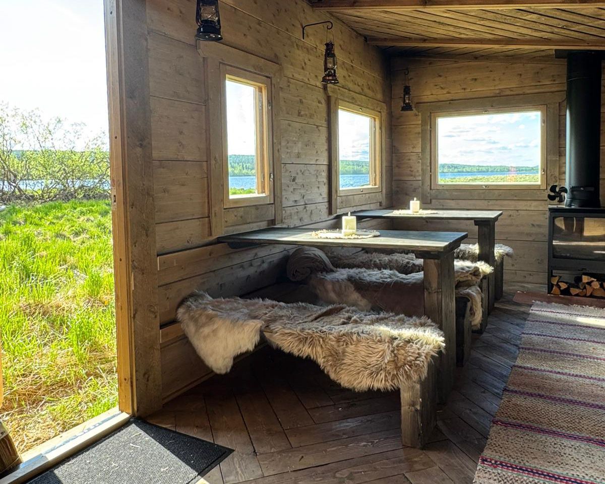 Log cabin with green river views