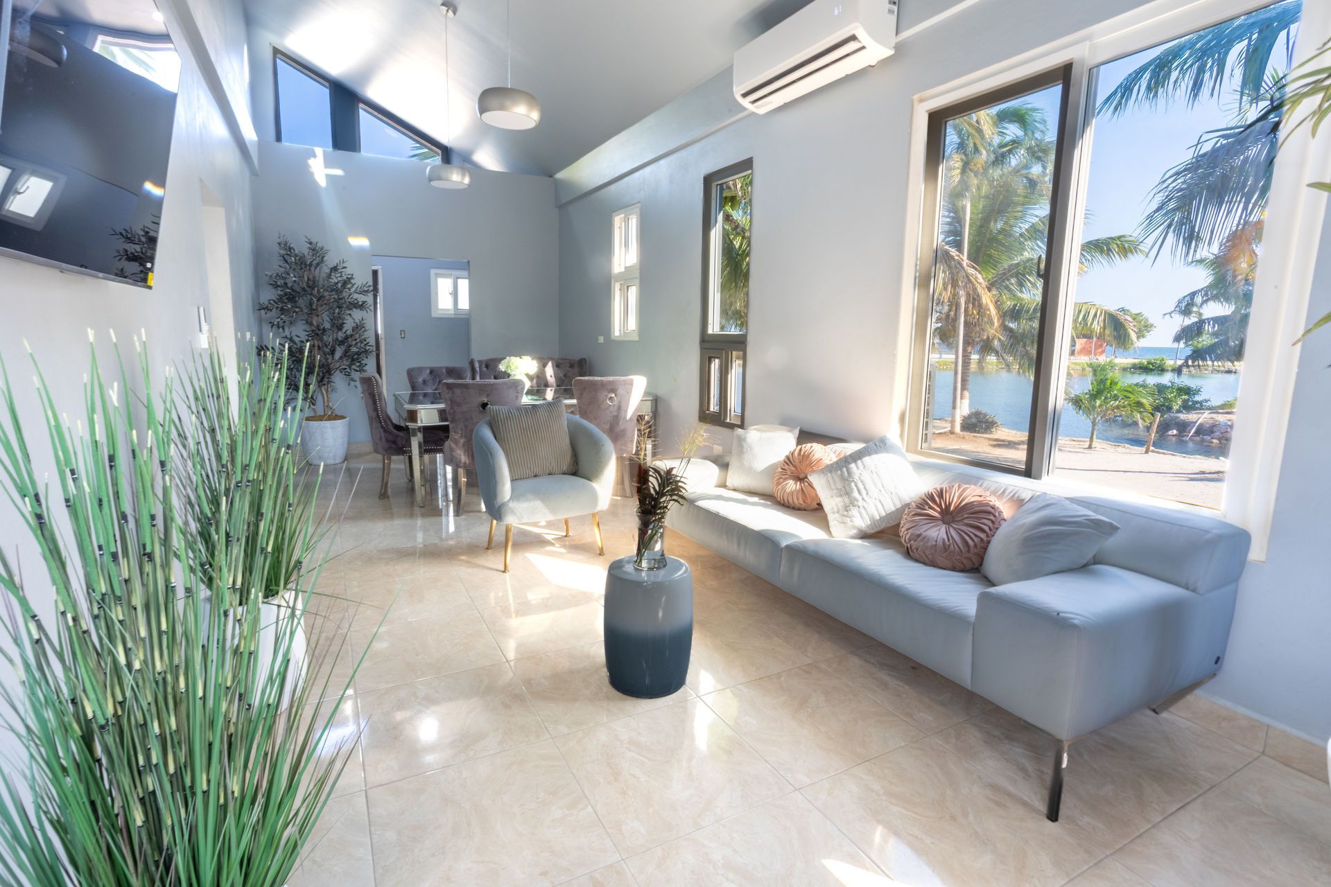 Basketball court by the ocean with a net and blue sky.