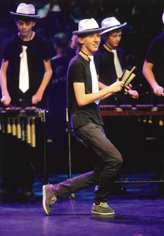 A group of young men are playing instruments on a stage.