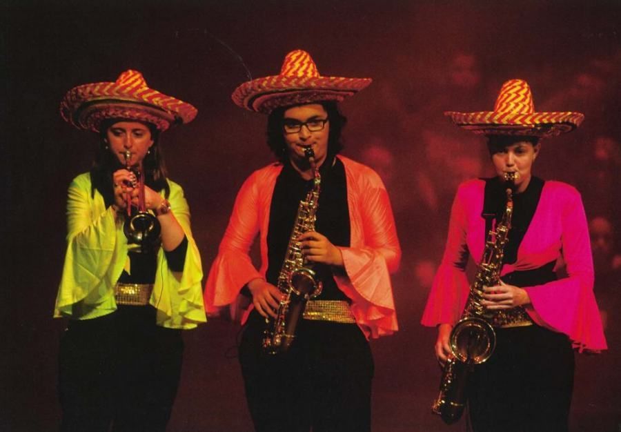 Three people wearing sombrero hats and playing saxophones