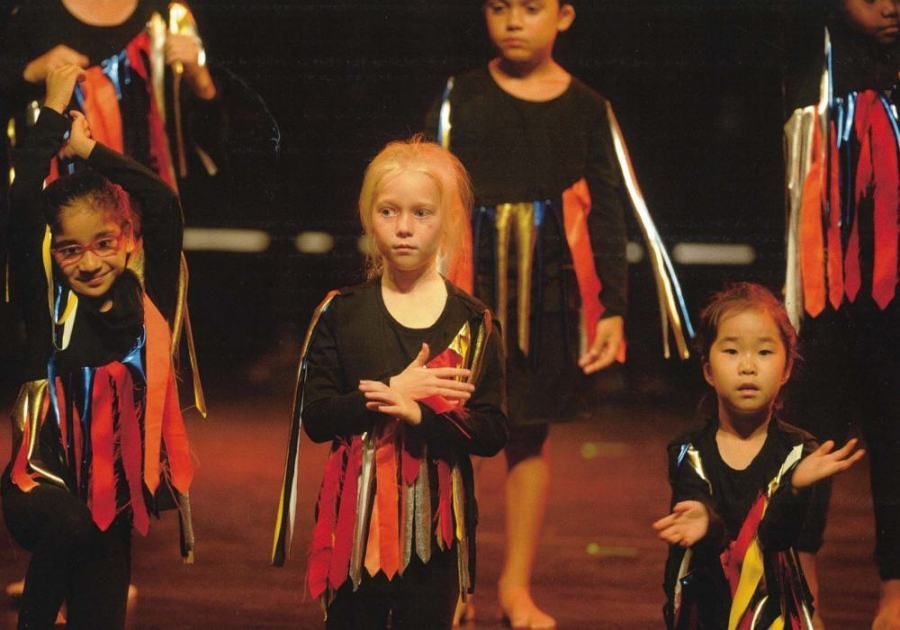 A group of young girls are performing on a stage