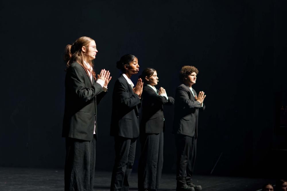 A group of people in suits are standing next to each other on a stage.