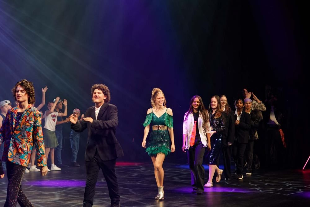 A group of people are walking on a stage.