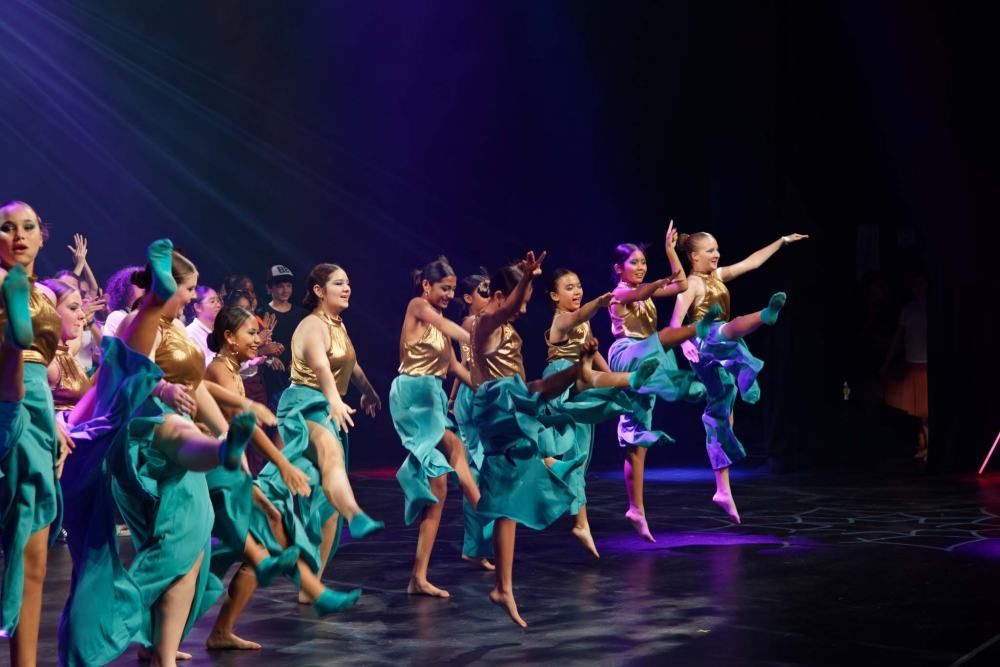 A group of young women are dancing on a stage.