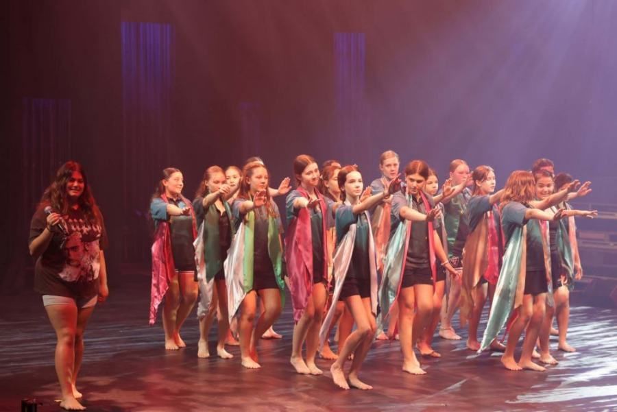 A group of young women are dancing on a stage.