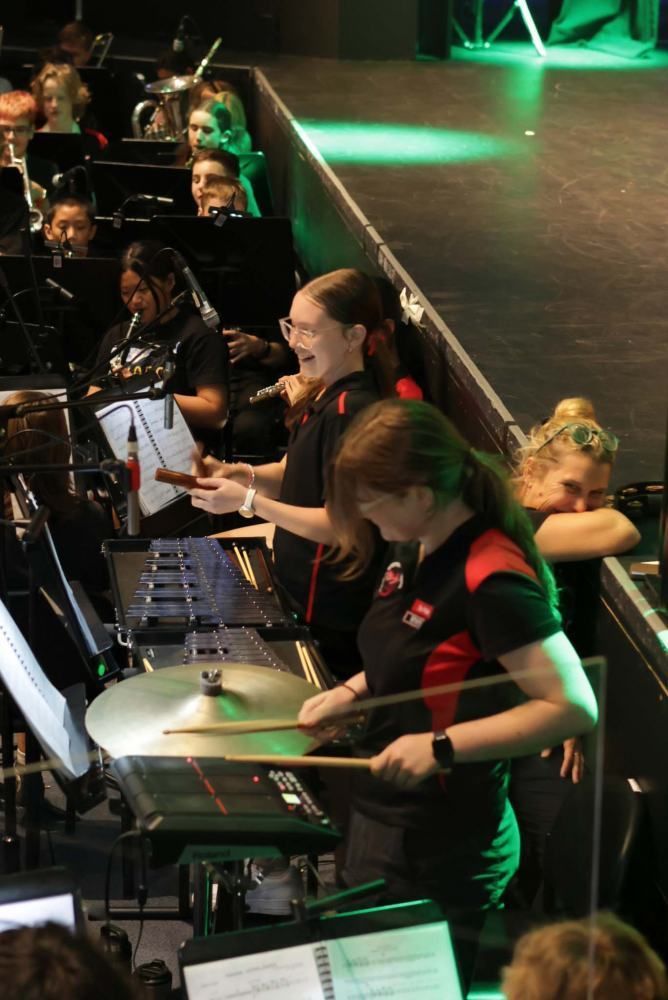 A group of people are playing drums on a stage.