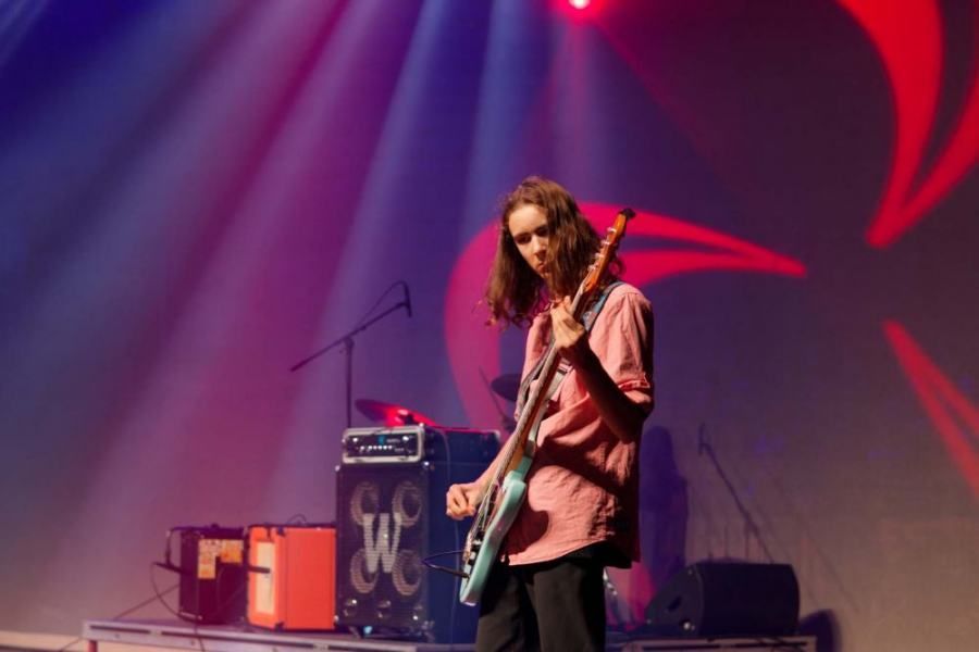 A man is playing a guitar on a stage.