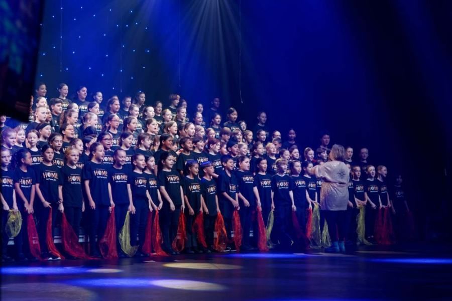 A large group of people are standing on a stage.